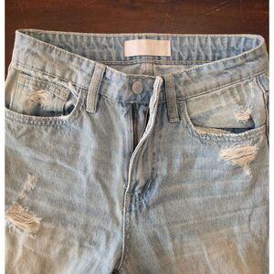 Size 24 high waisted light-wash Vervet jeans feature distressed detailing and a